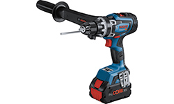 파란색 Bosch Professional 무선 드릴이 작업대 위에 놓여 있습니다.