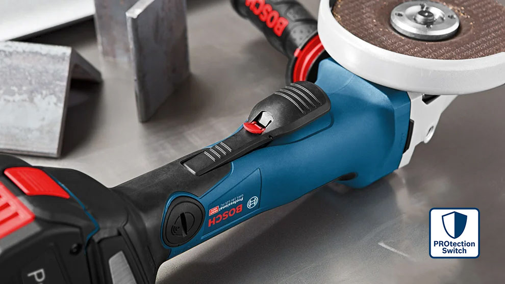 금속 표면에 액세서리가 있는 파란색 Bosch Professional 각도 그라인더.