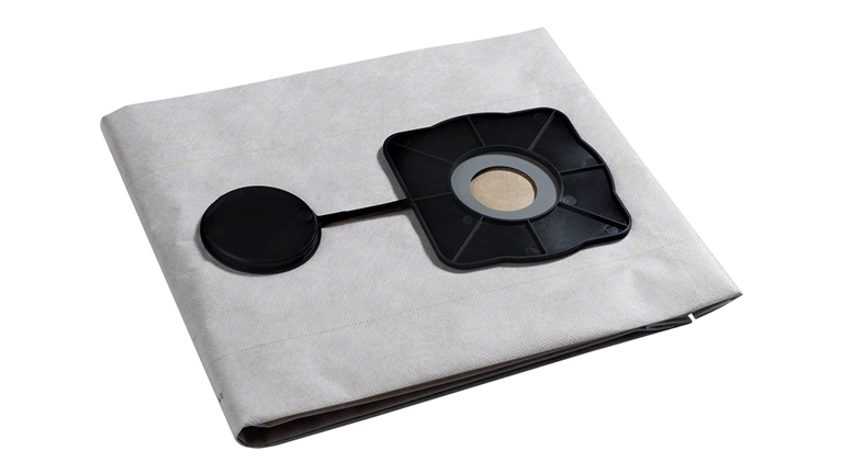 테이블 위에 회색 커버가 있는 검은색 Bosch Professional 도구.